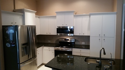 Plain white cabinets before Kitchen Facelifts refinishing