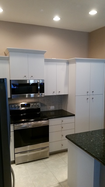 Before these plain white cabinets were refinished by Kitchen Facelifts of Southwest Florida