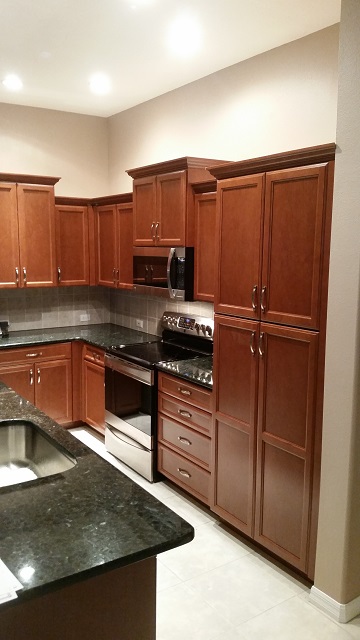 Kitchen Facelifts of Southwest Florida did a beautiful job refacing plain white cabinets with a rich wood style.
