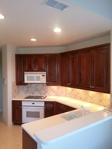 Kitchen Facelifts in Southwest Florida refaced these cabinets with a dark wood tone to update their look