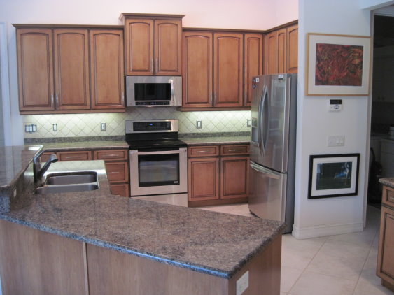 The cabinet refacing done for this kitchen matches the style of the interior and gives added value to the home