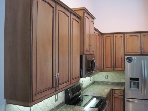 Kitchen Facelifts gave this kitchen warm wood tones to match the rest of the home's interior style