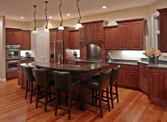 After cabinet refacing from Kitchen Facelifts, the dark wood on these cabinets complemented the interior style of the home.
